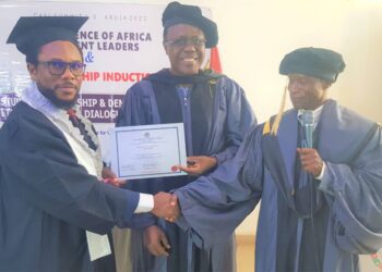 L-R: Mr Jude Nwauzor, Head, Corporate Communications Department, Asset Management Corporation of Nigeria (AMCON), receiving his certificate after the induction from Dr. Emmanuel C. Ihenacho, a member of Board of the Institute, and Dr Joseph Chinenyeze Ibekwe, the President/Chief Executive Officer of the Institute in Abuja...Thursday